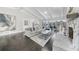 Bright living room featuring a stone fireplace, wood floors, and a large sectional sofa at 6313 Shoreland Cir, Buford, GA 30518