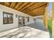 Spacious covered patio featuring a painted floor and exposed wood ceiling at 6313 Shoreland Cir, Buford, GA 30518