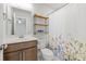 Bathroom features a single sink vanity, floral shower curtain, and modern shelving at 1436 Maston Rd, Auburn, GA 30011