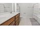 Bathroom featuring double sinks, tile flooring, and a shower/tub with a patterned curtain at 1436 Maston Rd, Auburn, GA 30011