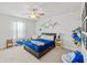 Bedroom with a plush carpet, bed, and window with shark decorations on the walls at 1436 Maston Rd, Auburn, GA 30011