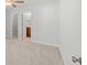 Neutral bedroom features a closet and a view into the attached bathroom with wood cabinets at 1436 Maston Rd, Auburn, GA 30011
