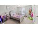 Light-filled bedroom featuring cute decor, plush carpet, and a window at 1436 Maston Rd, Auburn, GA 30011