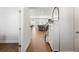 Bright foyer with hardwood floors, storage cabinet, and an open view of the staircase and living spaces at 1436 Maston Rd, Auburn, GA 30011