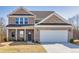 Charming brick home with a two-car garage, well-maintained lawn, and classic curb appeal at 1436 Maston Rd, Auburn, GA 30011