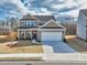 Beautiful two-story brick home with a well-kept front yard, inviting entrance, and attached two-car garage at 1436 Maston Rd, Auburn, GA 30011