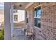 Charming covered front porch features ample natural light, brick detail, and cozy seating at 1436 Maston Rd, Auburn, GA 30011