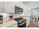 Modern kitchen features stainless steel appliances, white cabinets, and stylish backsplash at 1436 Maston Rd, Auburn, GA 30011