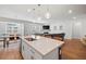 Open concept kitchen with island, pendant lighting, and view into living area at 1436 Maston Rd, Auburn, GA 30011