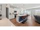 Bright kitchen boasts white cabinets, an island with seating, and stainless steel appliances at 1436 Maston Rd, Auburn, GA 30011