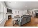 Bright living room featuring hardwood floors, fireplace, and view of the staircase and front door at 1436 Maston Rd, Auburn, GA 30011