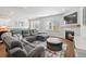 Comfortable living room featuring a gray sectional sofa, area rug, fireplace, and access to dining area and kitchen at 1436 Maston Rd, Auburn, GA 30011