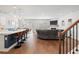 Open-concept living room with a fireplace, modern lighting, and seamless flow to the kitchen and dining area at 1436 Maston Rd, Auburn, GA 30011