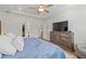 Comfortable main bedroom featuring a ceiling fan, tv and ample closet space at 1436 Maston Rd, Auburn, GA 30011