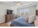 Cozy main bedroom featuring tray ceiling, large TV and a chair at 1436 Maston Rd, Auburn, GA 30011