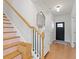 Staircase and front entrance, decorated with a wooden handrail and modern decor at 1436 Maston Rd, Auburn, GA 30011