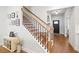 Staircase with wooden rails, black iron spindles, and natural light at 1436 Maston Rd, Auburn, GA 30011