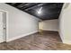 Unfinished basement area featuring a dark painted ceiling and hardwood floors throughout at 2148 Vicki Ln, Cumming, GA 30041