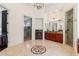 Well-lit bathroom with marble floors, glass enclosed shower and dark wood cabinets at 2148 Vicki Ln, Cumming, GA 30041