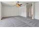 Spacious bedroom featuring plush gray carpeting and a stylish ceiling fan with decorative lighting at 2148 Vicki Ln, Cumming, GA 30041