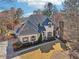 Beautiful home featuring a stone chimney, manicured landscaping, and a charming architectural design at 2148 Vicki Ln, Cumming, GA 30041