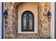 Elegant arched double front door featuring intricate ironwork and stone surround at 2148 Vicki Ln, Cumming, GA 30041