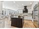 Spacious kitchen featuring white cabinetry, a black island, and stainless steel appliances at 2148 Vicki Ln, Cumming, GA 30041