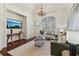 Elegant living room with wainscoting, large window, chandelier, and hardwood floors at 2148 Vicki Ln, Cumming, GA 30041