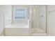 Bathroom featuring a tub, shower, and decorative window at 2623 Bloom Cir, Tucker, GA 30084