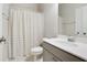 Clean bathroom features a vanity with ample countertop space and neutral shower curtain at 2623 Bloom Cir, Tucker, GA 30084