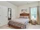 Cozy bedroom with a wooden headboard bed, bedside table and natural light from the window at 2623 Bloom Cir, Tucker, GA 30084