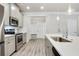 Modern kitchen with stainless steel appliances and a large island with a sink at 2623 Bloom Cir, Tucker, GA 30084