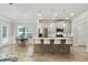 Modern kitchen featuring stainless steel appliances, an island with seating, and an adjacent dining area at 2623 Bloom Cir, Tucker, GA 30084
