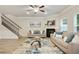 Cozy living room with fireplace, ceiling fan, staircase, and large rug at 2623 Bloom Cir, Tucker, GA 30084