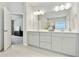Bright main bathroom with double vanity, modern fixtures, and tiled floors at 2623 Bloom Cir, Tucker, GA 30084