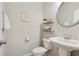 Half bath with pedestal sink, decorative shelves, and neutral wall paint at 2623 Bloom Cir, Tucker, GA 30084