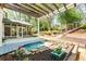 Serene backyard featuring a charming pond, a screened-in porch, and a meticulously landscaped garden at 356 Ivy Glen Cir, Avondale Estates, GA 30002