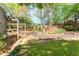 Beautifully landscaped backyard with a pergola, lush greenery, and a well-maintained lawn at 356 Ivy Glen Cir, Avondale Estates, GA 30002