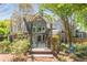 Charming backyard view with a walkway leading to an arched entryway and a spacious patio at 356 Ivy Glen Cir, Avondale Estates, GA 30002