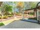 Expansive backyard with a koi pond, concrete patio, multilevel terraces, and mature trees at 356 Ivy Glen Cir, Avondale Estates, GA 30002