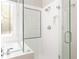 Modern bathroom featuring a glass-enclosed shower and a soaking tub under a frosted glass window at 356 Ivy Glen Cir, Avondale Estates, GA 30002