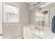 Bright bathroom featuring a large mirror, single sink vanity, and natural light from the window at 356 Ivy Glen Cir, Avondale Estates, GA 30002
