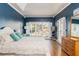 Large bedroom with hardwood floors, a tray ceiling, and large windows with views of the landscaped yard at 356 Ivy Glen Cir, Avondale Estates, GA 30002
