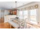 The dining area is illuminated by a modern light fixture with wooden floors and large windows at 356 Ivy Glen Cir, Avondale Estates, GA 30002