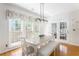 This bright dining area features a modern light fixture, bench seating and an exit door at 356 Ivy Glen Cir, Avondale Estates, GA 30002