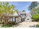 Charming two-story home with gray siding, manicured lawn, and attached two-car garage on a sunny day at 356 Ivy Glen Cir, Avondale Estates, GA 30002