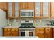 Well-equipped kitchen with stainless steel appliances, granite countertops, and ample storage space in cabinets at 356 Ivy Glen Cir, Avondale Estates, GA 30002