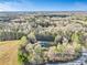 Far-off view of home surrounded by trees and open fields at 8445 Vernon Grove Rd, Chattahoochee Hills, GA 30268