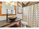 Bathroom featuring a vessel sink, wood accents, and a shower with a stylish curtain at 8445 Vernon Grove Rd, Chattahoochee Hills, GA 30268