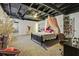 Spacious bedroom with a dark wood bed frame, stylish shelving and carpet at 8445 Vernon Grove Rd, Chattahoochee Hills, GA 30268